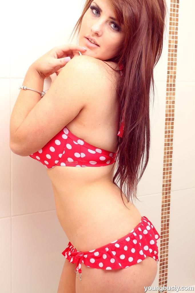 Beautiful redhead teen Robyn wets her big natural breasts in the bathtub