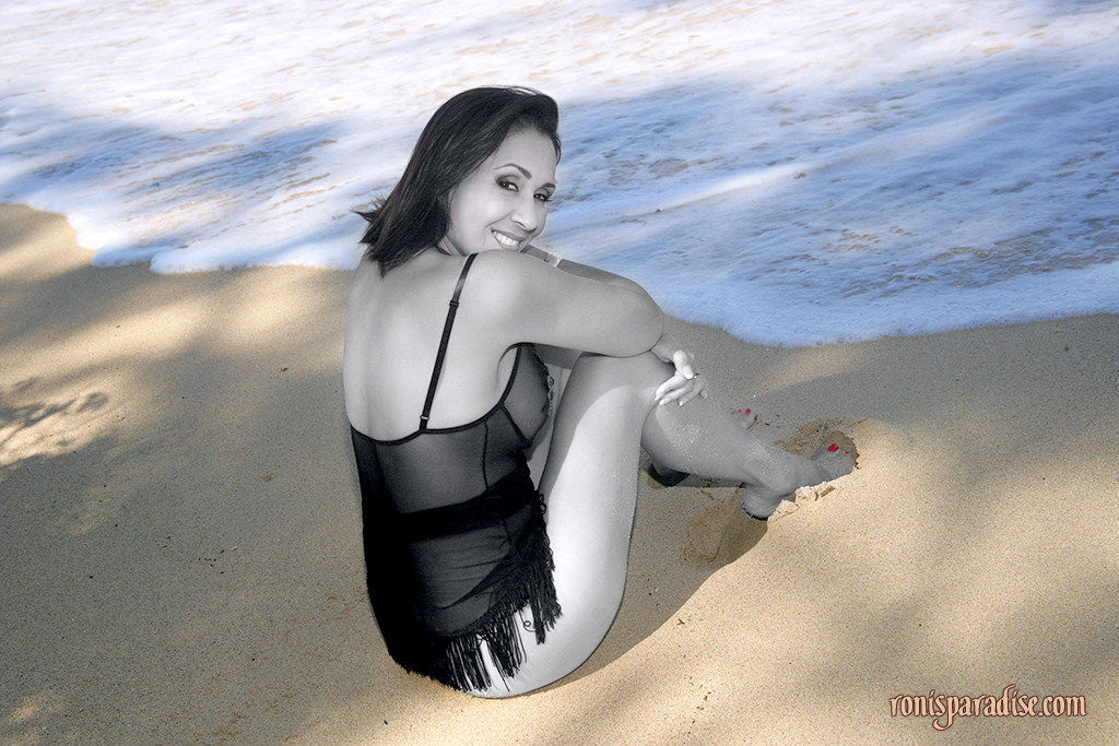 Long legged mature Roni posing on the beach in black lacy pantyhose