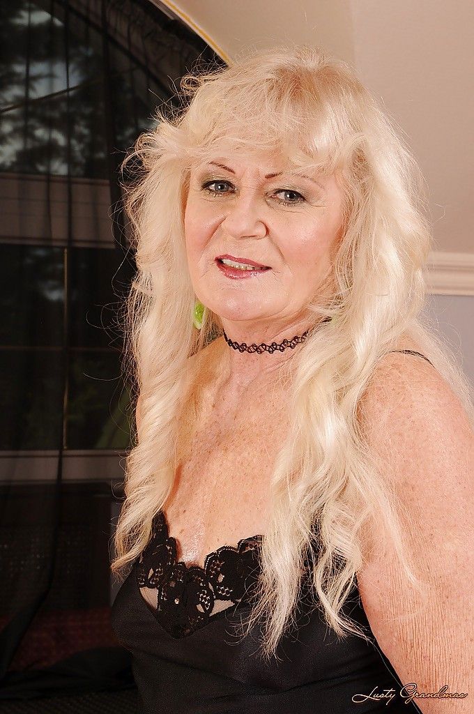 Blond Oma in kousen strippen en poseren naakt op De Bed