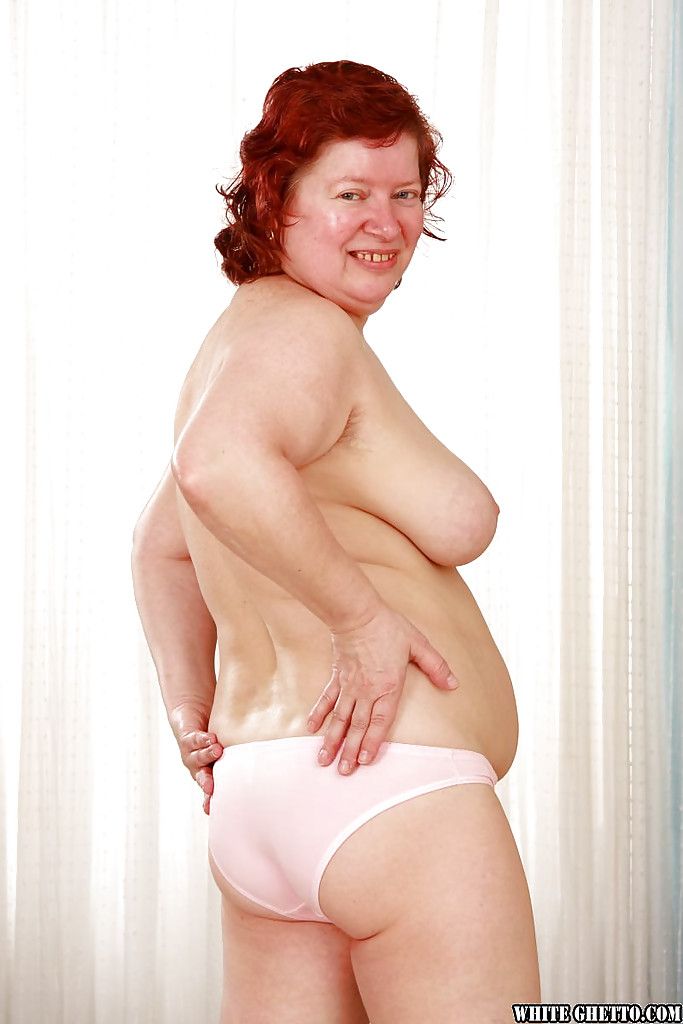 Fatty redhead granny with massive jugs stripping off her clothes
