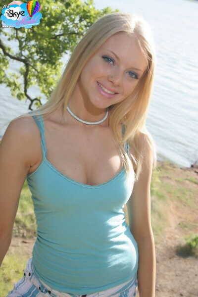Cute blonde teen Skye Model drops her shorts lakeside to pose in white panties