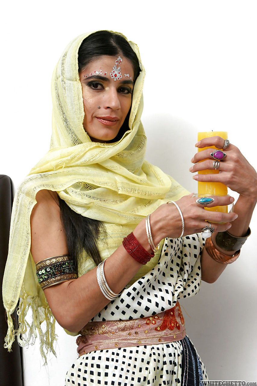 Indian solo model Tamara setting up candles for worship wit her clothes on