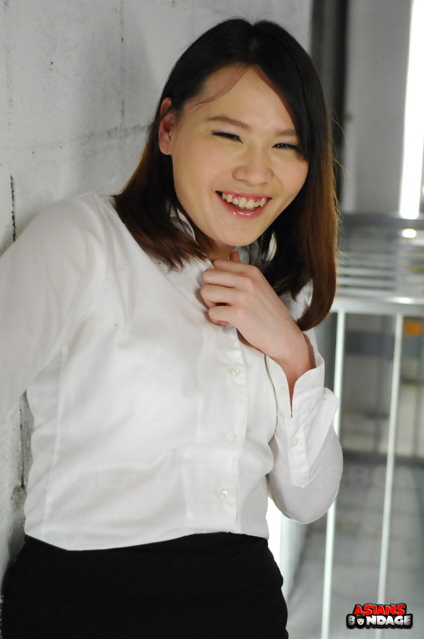 Asian chick Aki Sasahara is fitted with gag in white blouse and black skirt