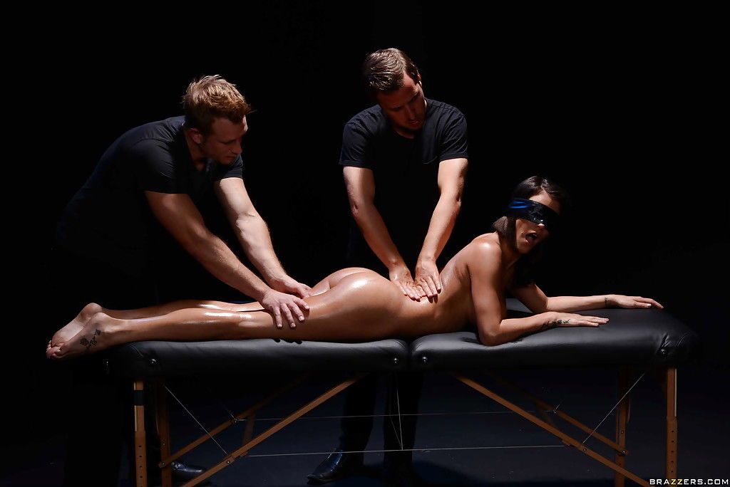 Blindfolded pornstar Peta Jensen is massaged by two men before DP