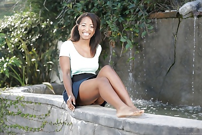 Young black chick Serena Blair flashing upskirt panties outdoors